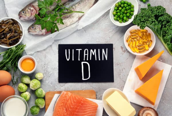 Foods high in vitamin D on light background.