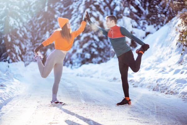 Fitness couple doing exercise at winter day
